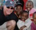 Man posing with young children.