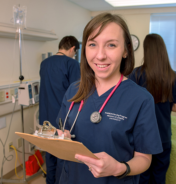 MSJ female graduate smiling in nursing uniform in hospital.