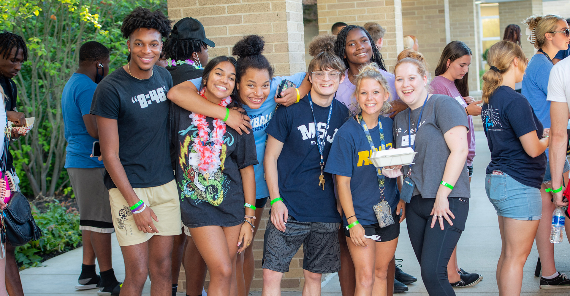 students hanging out outside in group smiling 