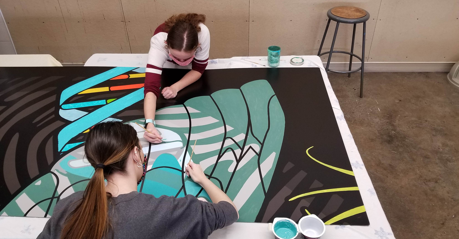 art guild students working on cicada mural.