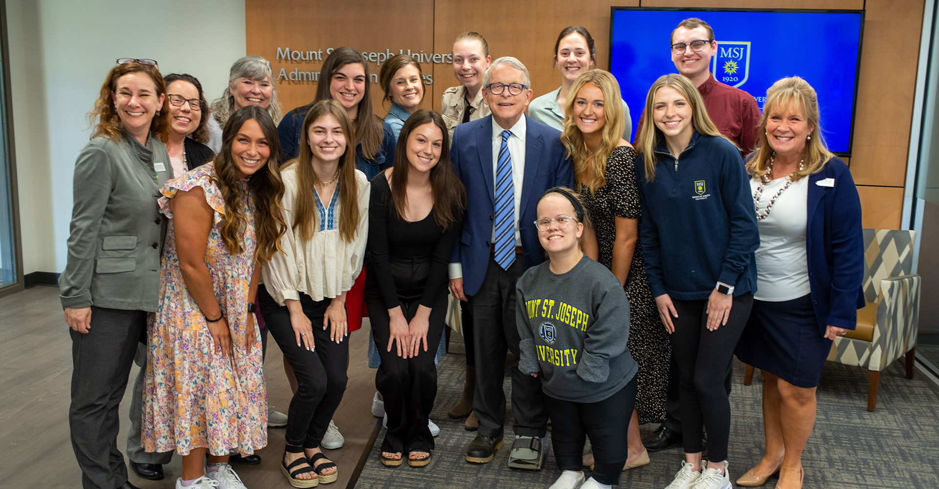 MSJ education group standing with governor dewine smiling