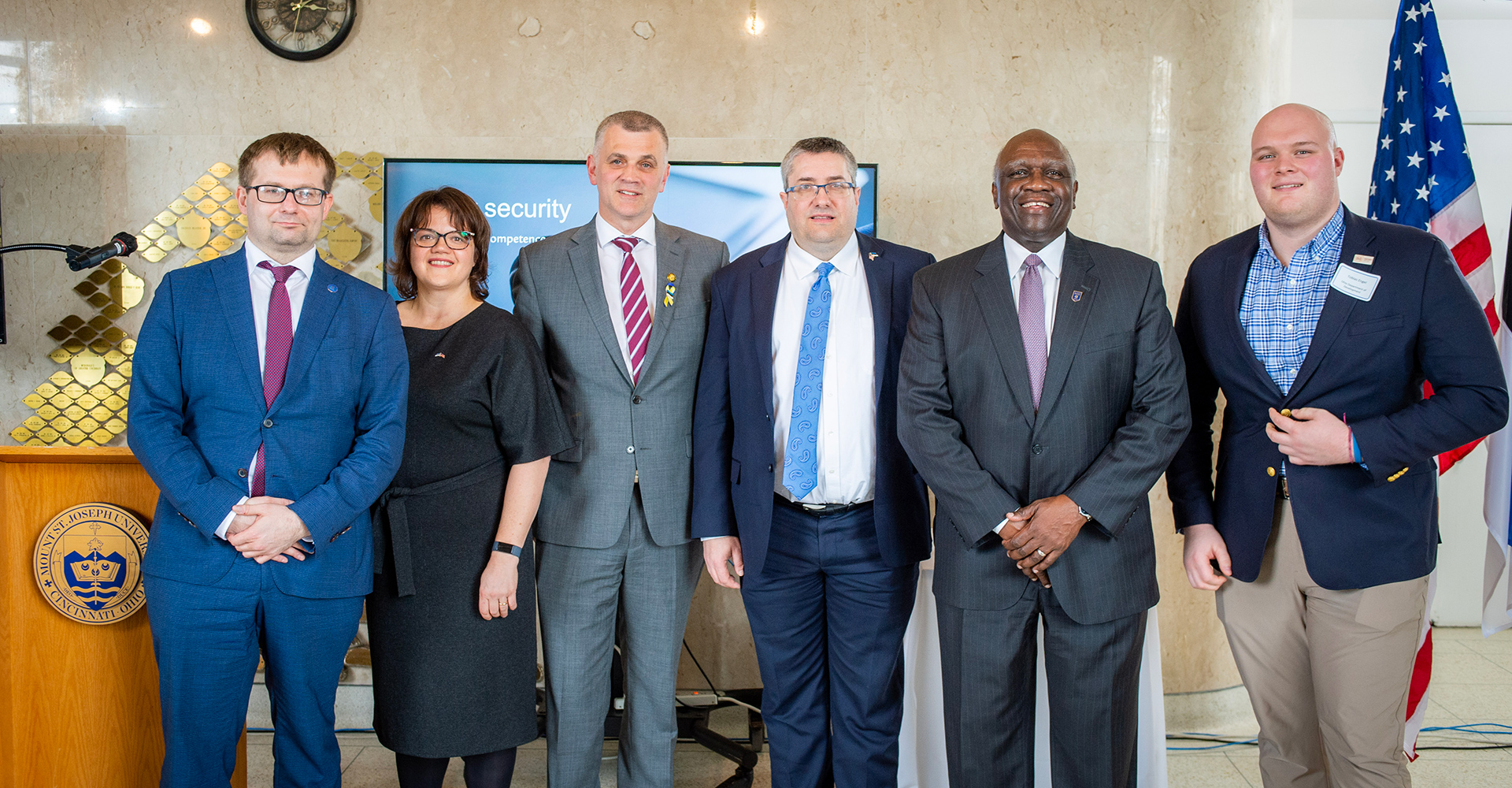 estonian ambassador with president williams and faculty in theatre gallery.
