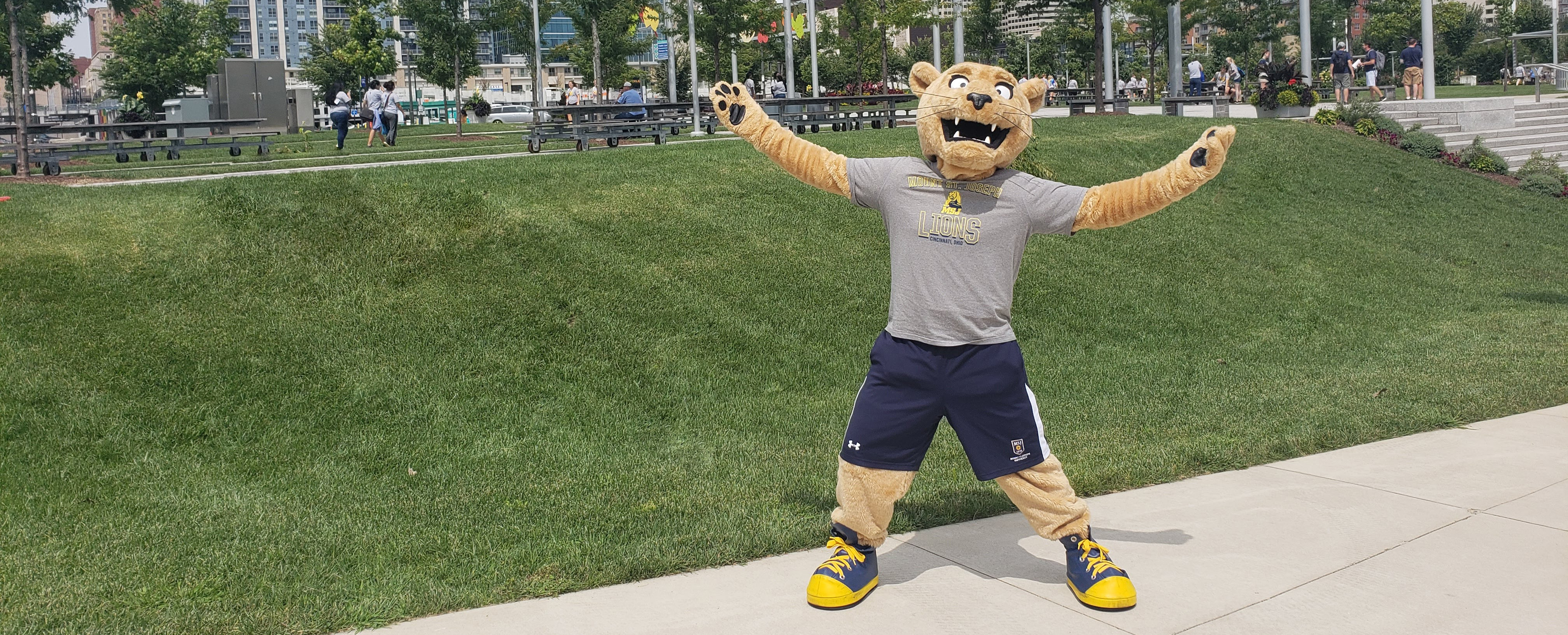 Joe the Lion mascot in front of crowd