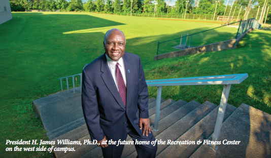 University President standing on campus.