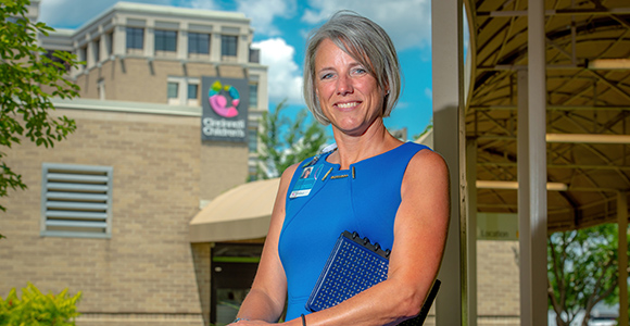 Mount St. Joseph University alumna becky rengering standing in front of children's hospital