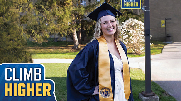 Kara Bradley smiling in MSJ graduation gown