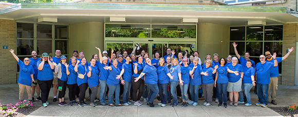 employees in a big group smiling