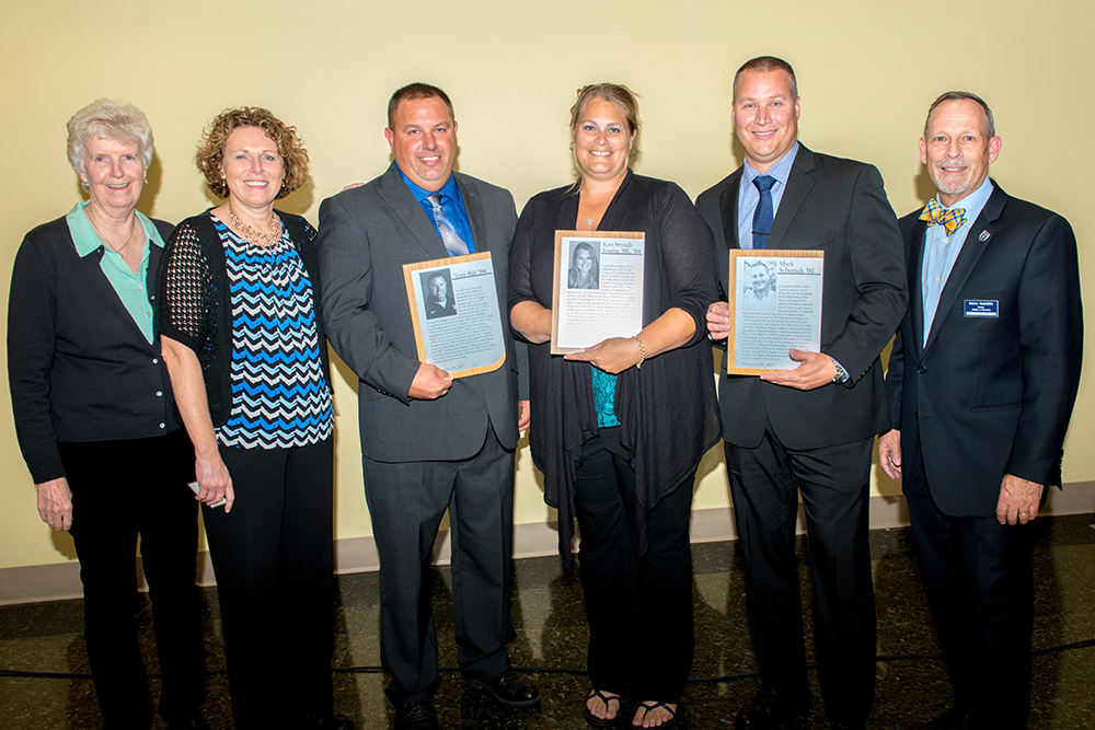 MSJ Athletic Hall of Fame inductees holding plaques.