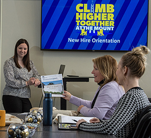 employees reviewing benefits at desk