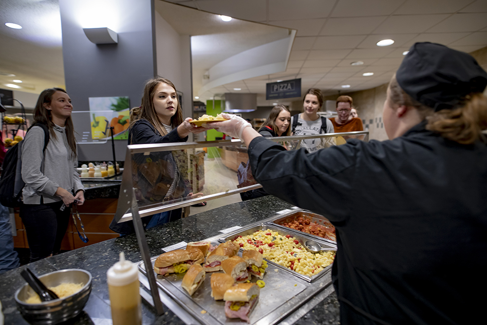 MSJ students in Fifth Third Dining Hall receiving food from dining staff.