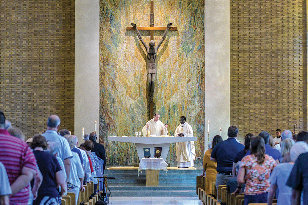 priest doing mass in mater dei chapel at mount st. joseph university.