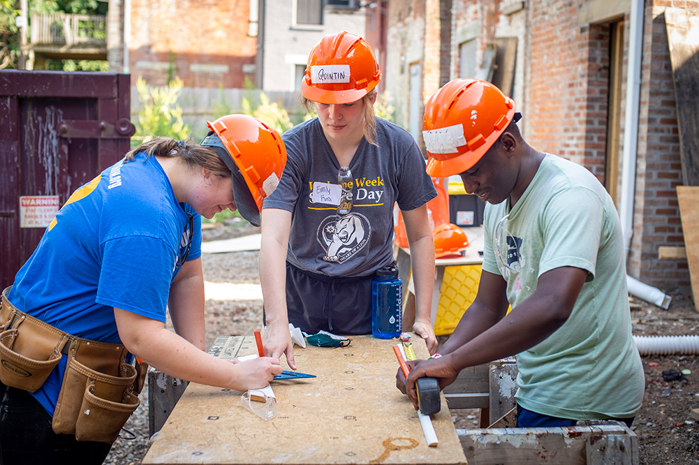 MSJ mission ambassadors working on wood cutting for service day.