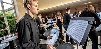 Students performing at a steel drum band concert.