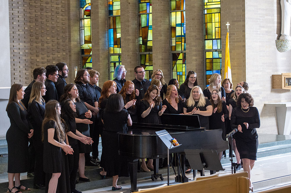 The MSJ Choir posing with and organ in Mater Dei Chapel.