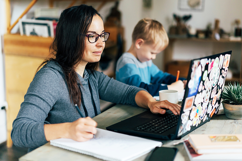 adult student working next to her child