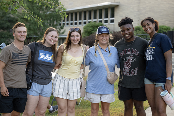 students in quad smiling next to each other