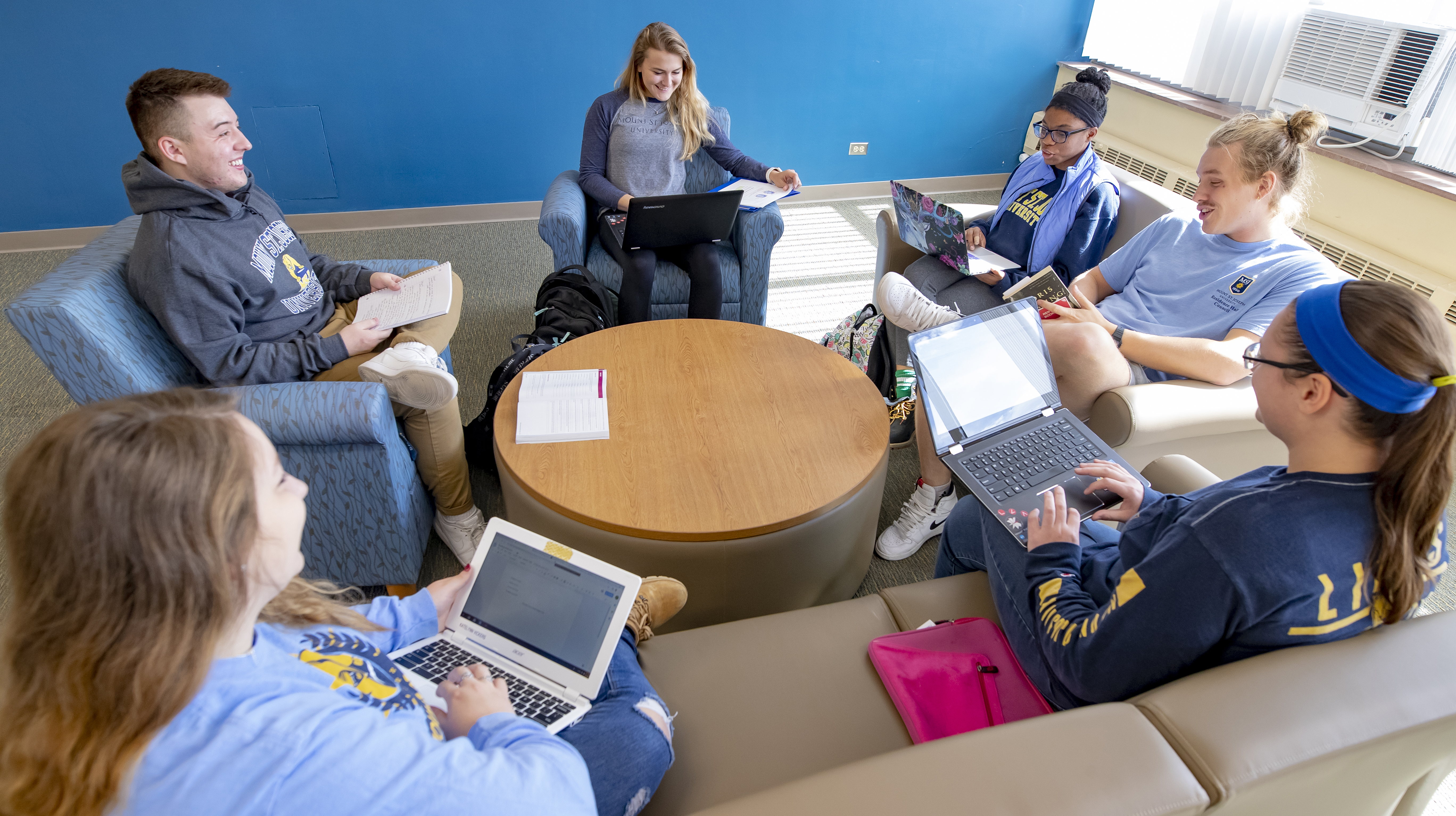 students gathered around a desk