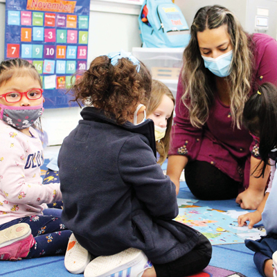 Teacher helping kids with math