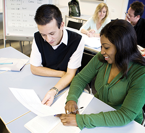 employees reviewing benefits at desk