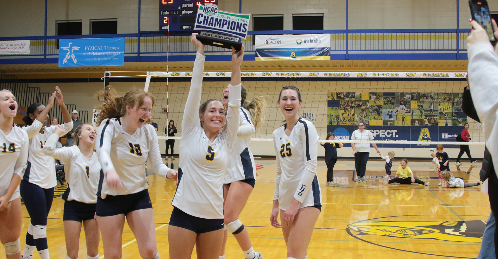 volleyball players jumping in triumph over championship win