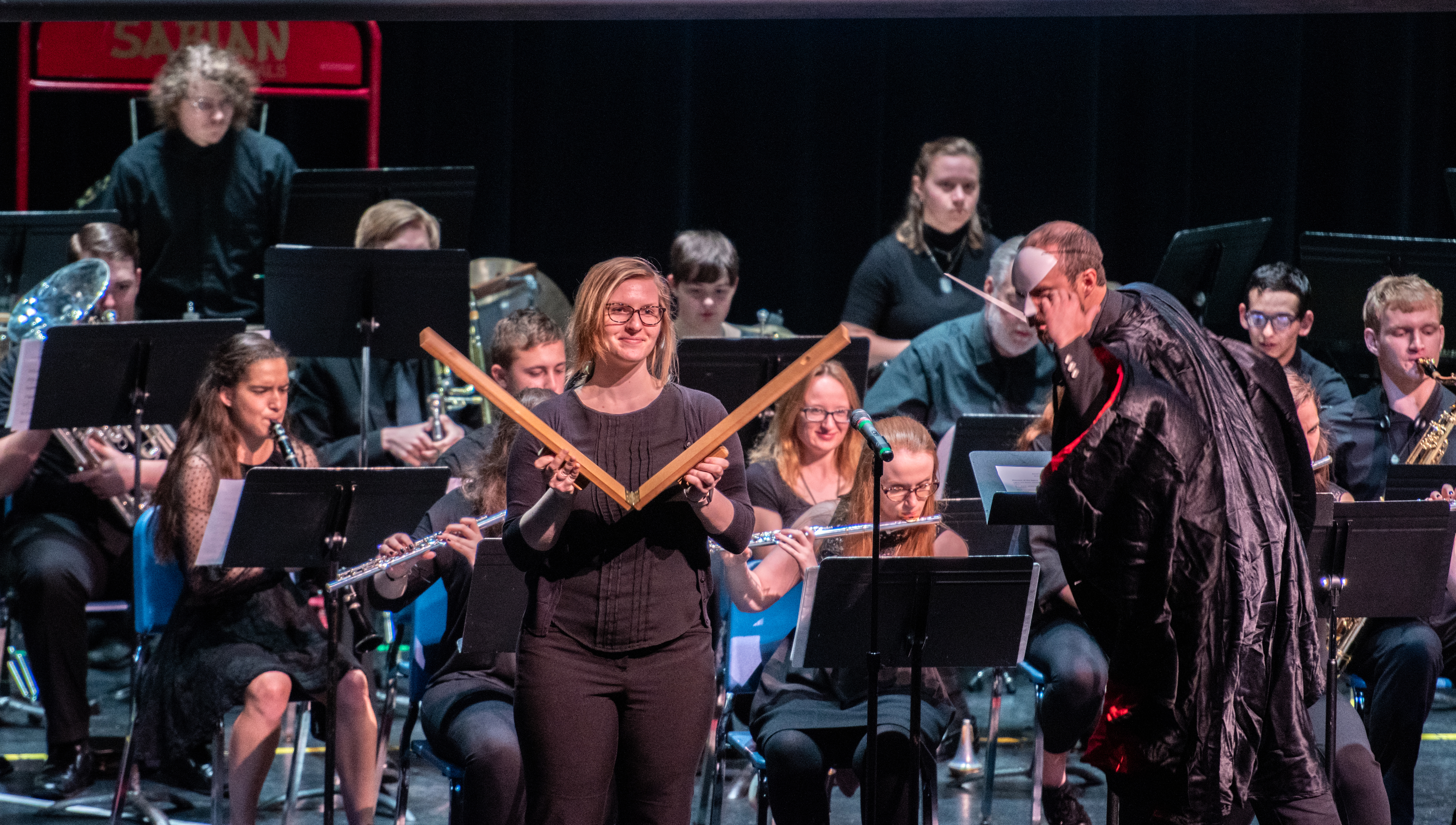 students playing instruments in band on stage