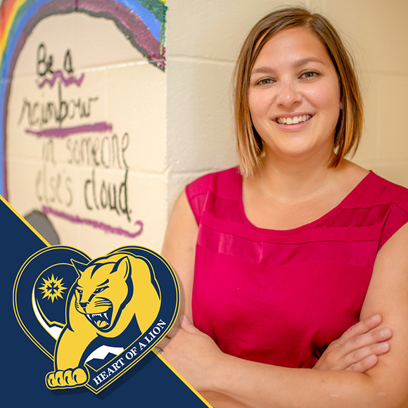 teacher standing outside classroom door