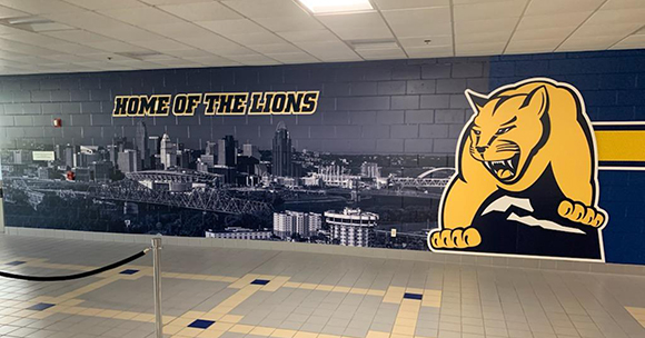 harrington mural in lobby with cityscape 