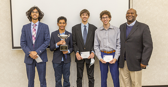 high school business students standing with award.