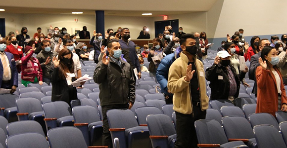 citizens taking oath in university theatre.