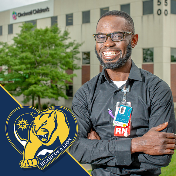 MSJ graduate standing in front of hospital