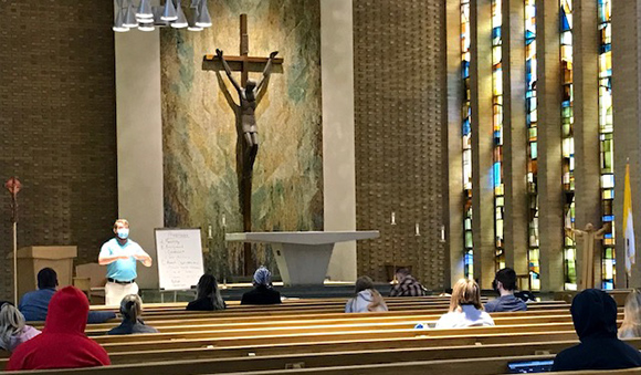 students sitting in chapel for class