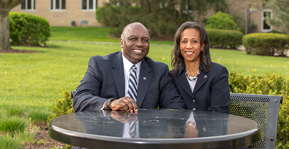 President H. James Williams and Carole Williams in MSJ quad smiling.