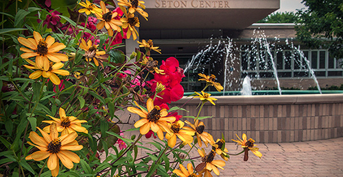 Mount St. Joseph spring flowers in front of Seton fountain entrance.