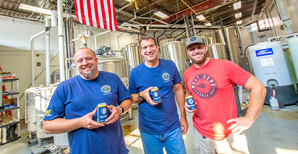 tim lawson in group photo holding his award-winning beer