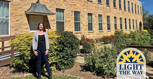 Mount St. Joseph University alumna maria eichhold standing in front of building, In My Shoes organization.