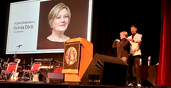 Mount St. Joseph University professor sylvia dick on stage receiving her award.