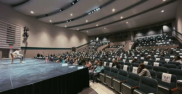 boland speaking in Seton high school theatre.