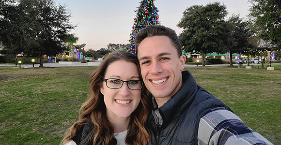 Mount St. Joseph University graduates smiling as a couple in park