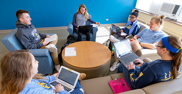Mount St. Joseph University students sitting around table on laptops