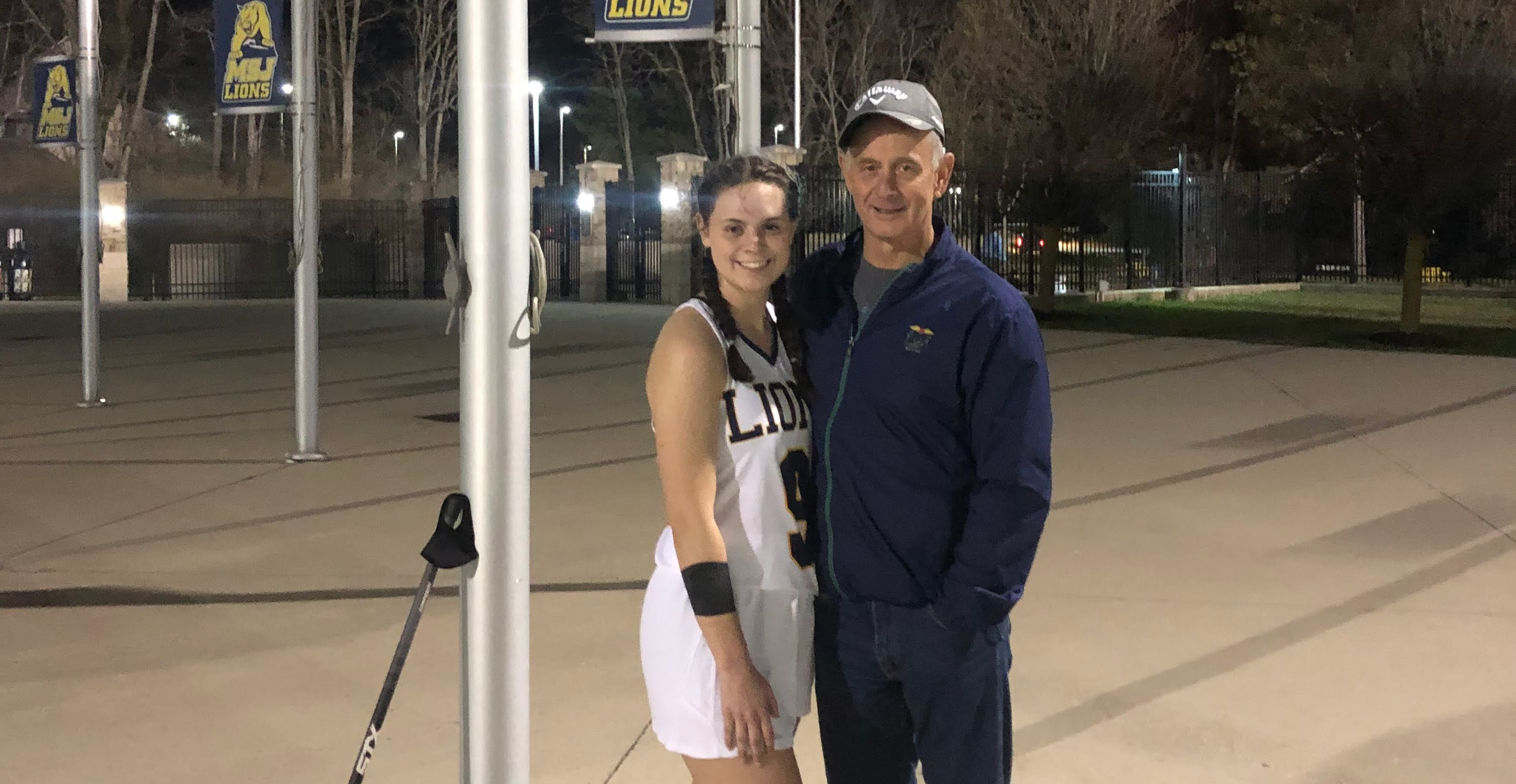 savannah next to her dad after a MSJ lacrosse game.