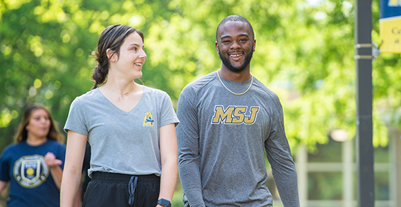 Mount St. Joseph University transfer students walking around the campus quad.