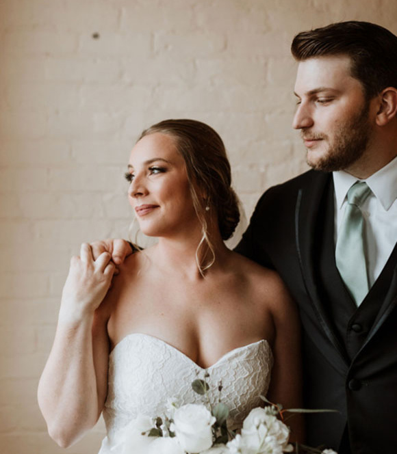 MSJ couple in wedding attire looking to the left