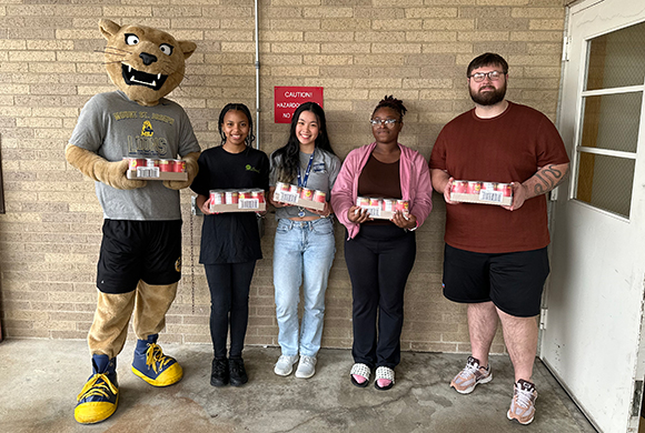 food pantry holding cans of chili
