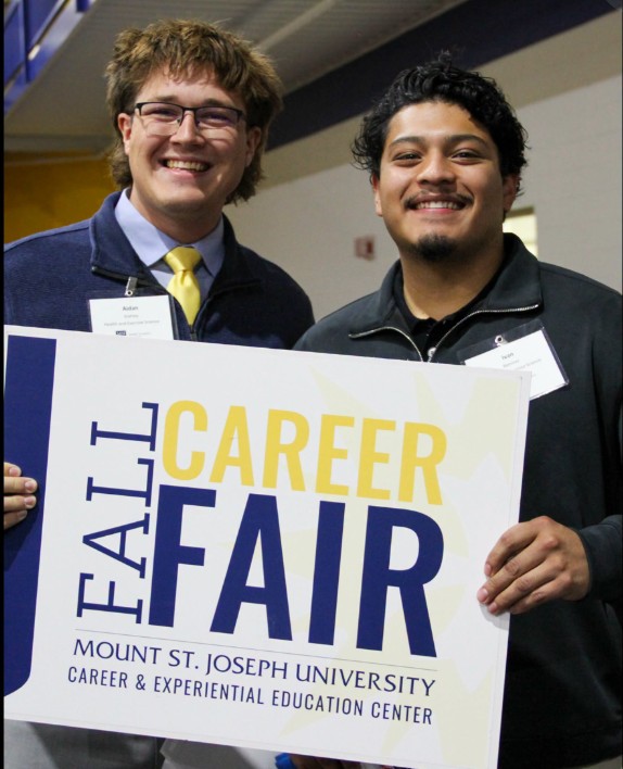students holding a career fair sign 