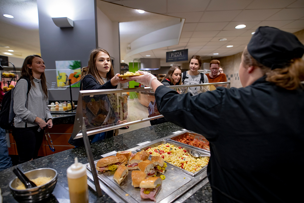 MSJ student receiving food on plate in Dining Hall at Mount St. Joseph University