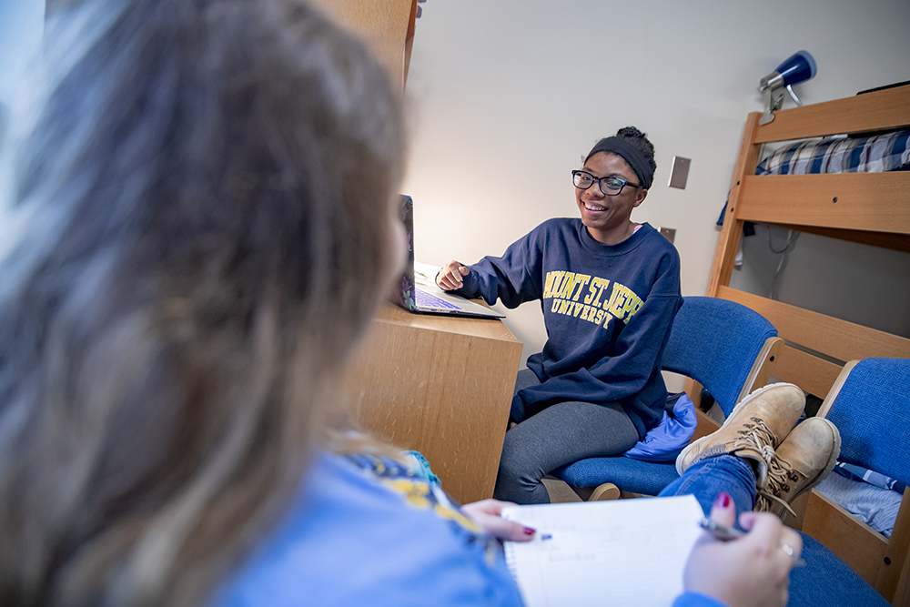 students in dorm doing homework.